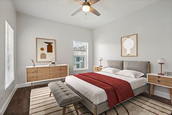 A bedroom with a bed, nightstand, and chair.